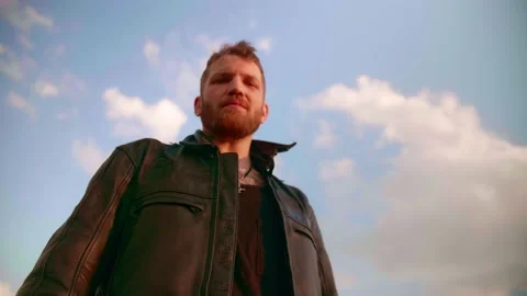 A middle-aged man in a leather jacket. Portrait at sunset Stock Footage 154808467