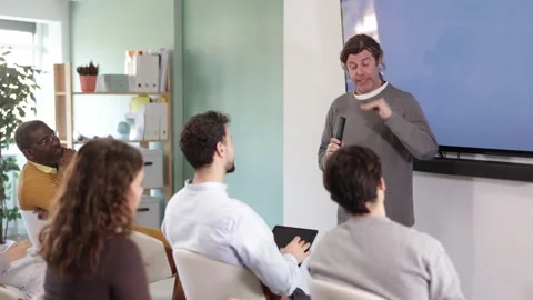 Middle aged man lecturer speaks to worker audience of listeners Stock Footage 341784882