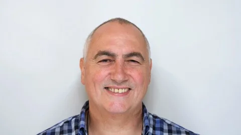 Middle aged man looking and smiling at camera isolated on white background Vídeos de archivo 115409991