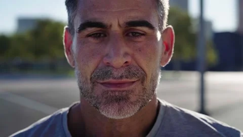 Middle-aged man looking at the camera with determination, heavily breathing Stock Footage 267696235