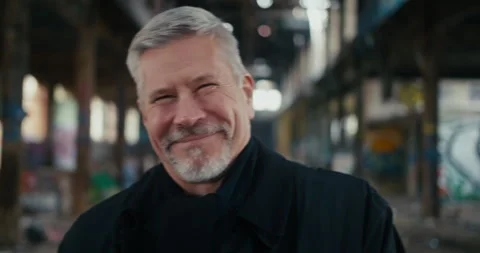 A middle aged man looking in the camera and laughing uncontrollably. Stock Footage 300790191