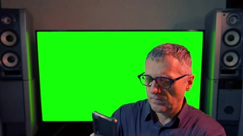 Middle-aged man looking at his smartphone with a concerned look Stock Footage 167167423