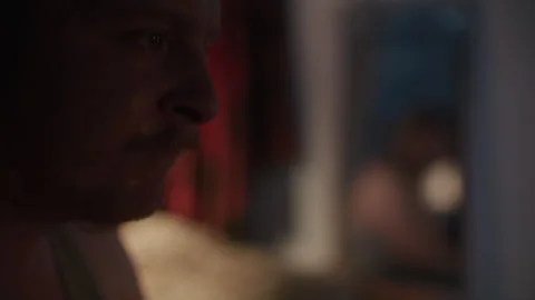 A middle aged man looking outside the window and looking sad Video stock 259688821