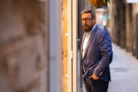 Middle-aged man looking at store window outside Stock Photos