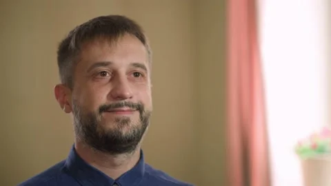 Middle aged man. Looks in the mirror. smiles 動画素材 169031014