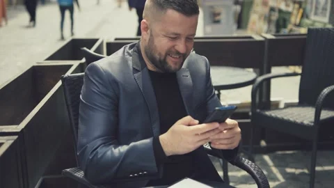 Middle-aged man in luxurious clothes answers the call of his mobile phone. Stock Footage 172504601