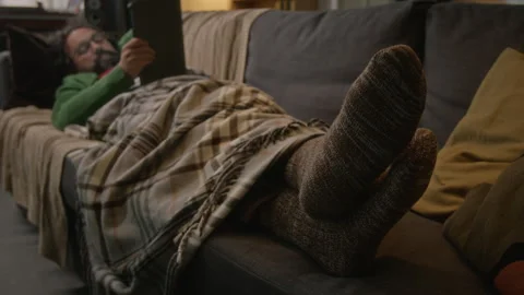Middle Aged Man Lying on Sofa Using Tablet Computer at Home Stock Footage 341674251