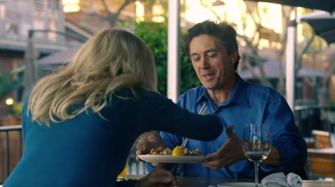 Middle-aged man offers his sushi appetizer to his wife Stock Footage 59744103