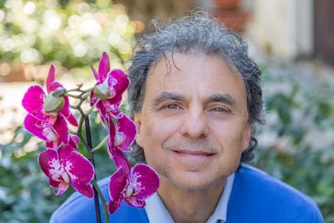 Middle-aged man with orchid Stock Photos