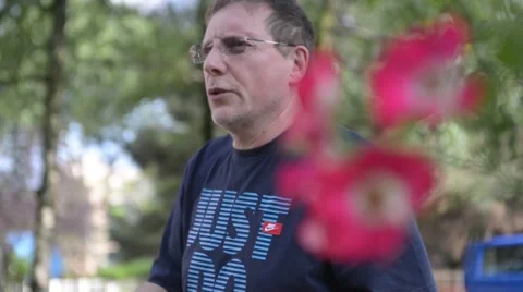 Middle-aged man in the park is actively communicating Stock Footage 51875315