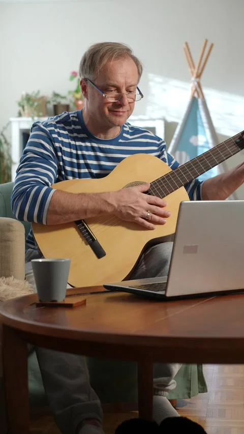 A middle-aged man playing an acoustic guitar. Stock Footage 303781352