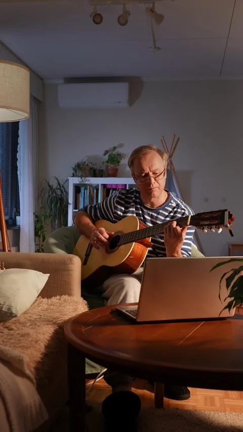 A middle-aged man playing an acoustic guitar. Stock Footage 303781412