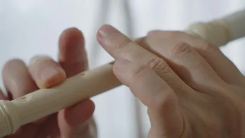 A middle-aged man playing recorder flute. Stock Footage 303782273