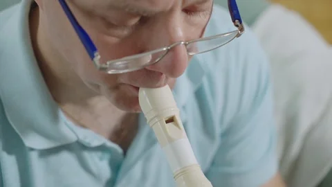 A middle-aged man playing recorder flute. Stock Footage 303782282
