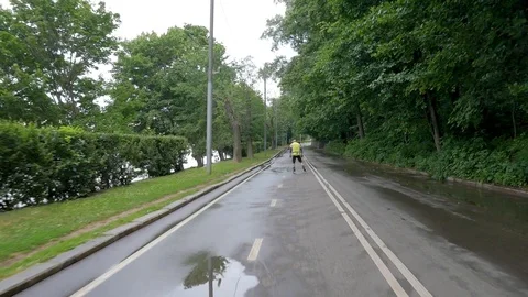 Middle-aged man, practicing roller skiing with sticks Stock Footage 113060669