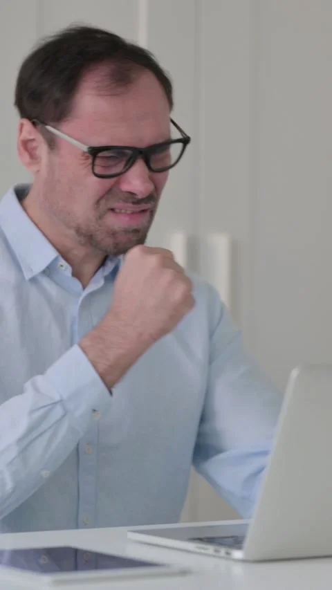Middle Aged Man Reacting to Loss While using Laptop in Office, Vertical Video 스톡 동영상 339584586