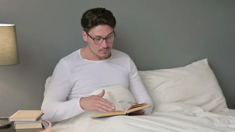 Middle Aged Man Reading Book in Bed 스톡 동영상 142371161