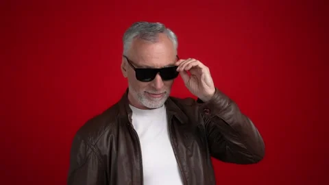 Middle aged man ready disco touch specs isolated scarlet color background Stock Footage 166628820
