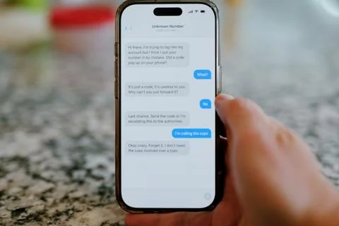 Middle Aged Man Recieves 2FA Intecept Scam Texts 写真素材