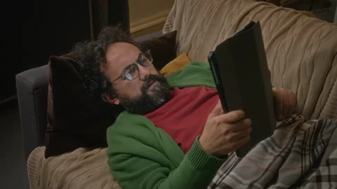 Middle-aged Man Relaxing Using Tablet Computer for Remote Work at Home Stock Footage 341677691