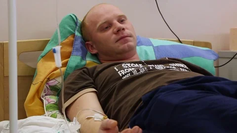 Middle-aged man rest hosp bed medical dropper drugs Stock Footage 81837326