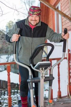 Middle aged man running on simulator Stock Photos