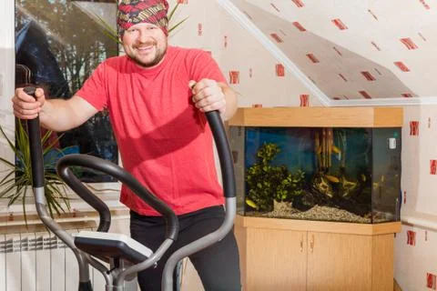 Middle aged man running on simulator Stock Photos