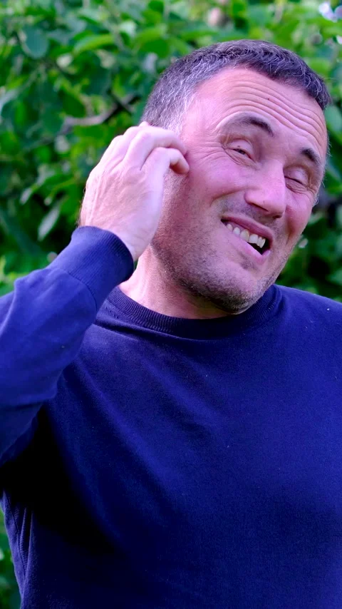 Middle aged man scratching head with puzzled expression and making funny faces Stock Footage 345743915