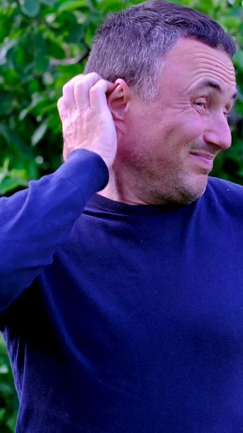 Middle aged man scratching head with puzzled expression and making funny faces Stock Footage 345745017