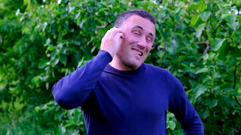Middle aged man scratching head with puzzled expression and making funny faces Stock Footage 345745576
