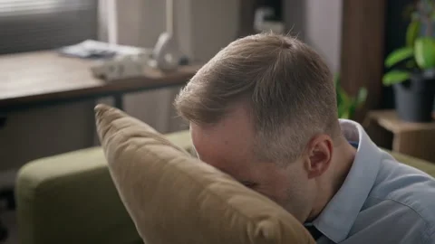 Middle Aged Man Screaming into Pillow during Therapy Session Stock Footage 340630715