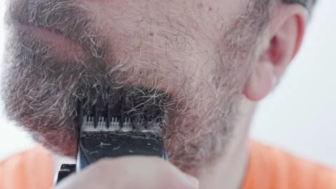 Middle aged man shaving with electric razor looking at bathroom mirror. Stock Footage 167282580