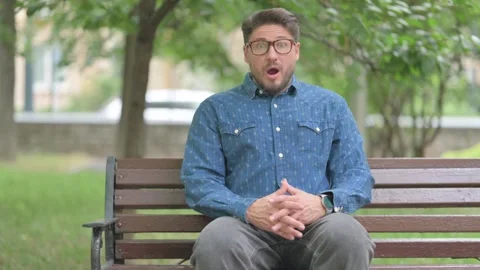 Middle Aged Man with Shocked Expression Looking at Camera Outdoors Video stock 311371104