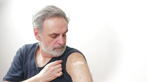 Middle-aged man showing the arm patch after the vaccination - immunization Stock Footage 169866909