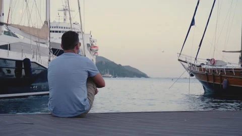 Middle-aged man sits 库存影片 141492131