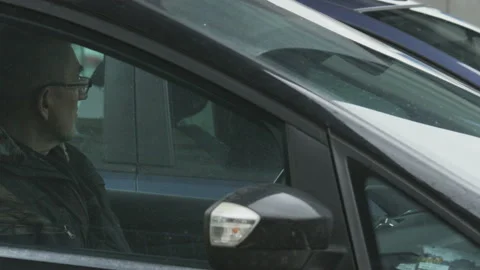 Middle-Aged Man Sitting in his Black Car Stock Footage 88573859