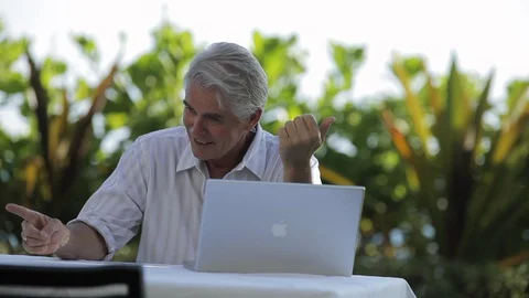 Middle-aged man sitting with a laptop. 스톡 동영상 88370105