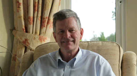 Middle aged man smiles at camera and takes off glasses Stock Footage 33605864