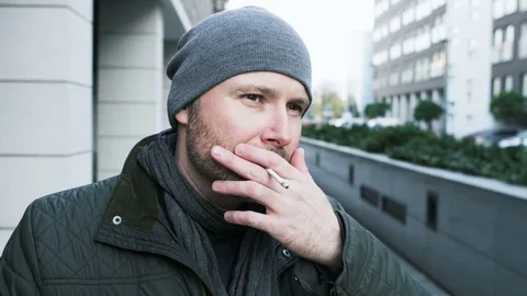 Middle-Aged Man Smoking a Cigarette in the Street Stock Footage 82174154