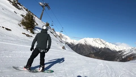 Middle-aged man snowboarding in Alps slow motion Stock Footage 103799637