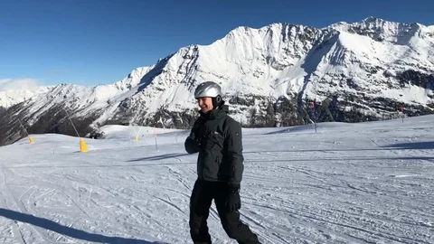 Middle-aged man snowboarding in Alps slow motion Stock Footage 103799641