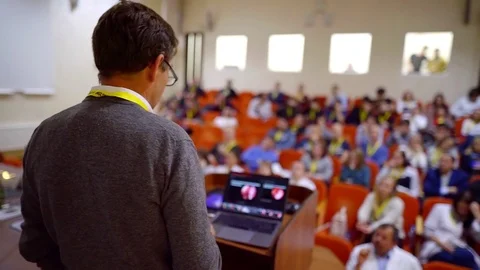 Middle aged man is speaking in hall of institute, teaching colleagues and Video stock 98411338