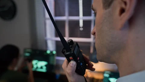Middle-aged Man Speaking into Portable Radio in Military Command Center Stock Footage 343737467