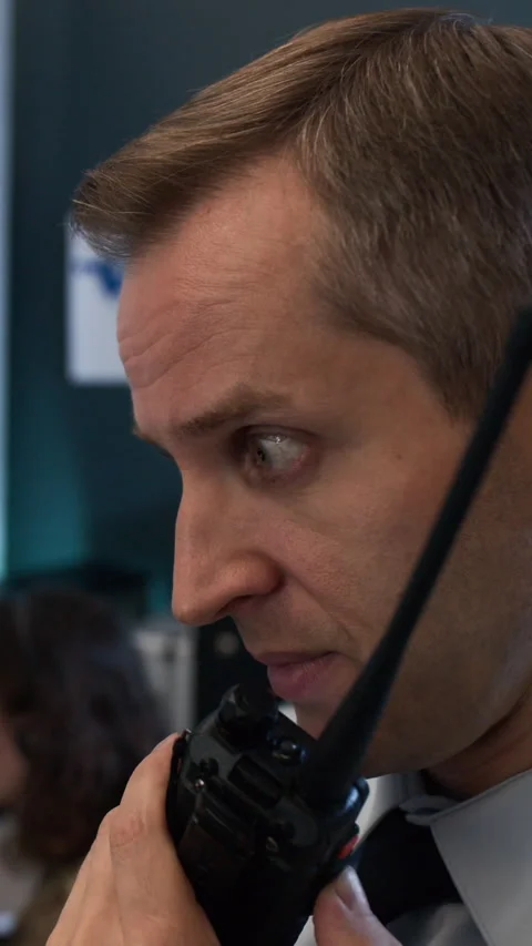 Middle-aged Man Speaking into Walkie-talkie in Military Command Center Stock Footage 343736896