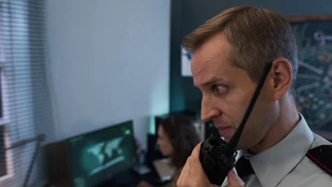 Middle Aged Man Speaking on Walkie Talkie in Military Command Center Stock Footage 343747858