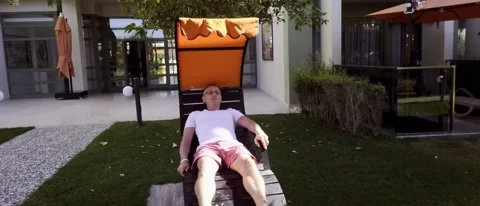 Middle-aged man spending quality time relaxing in a recliner Stock Footage 166218580
