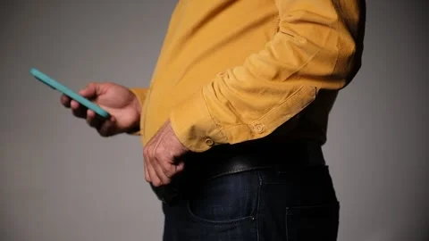 Middle-Aged Man Standing and Using a Smartphone 库存影片 318239119