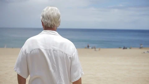 Middle-aged man standing on a beach. 動画素材 88369955