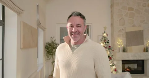 Middle-aged man standing by window sunlight drawing eye turning stepping smiling Stock Footage 344459482