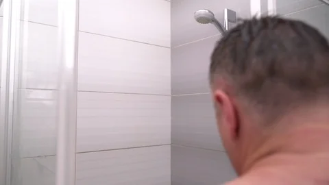 Middle aged man stepping into a shower Stock Footage 93937938